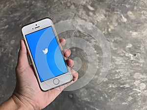 User is using twitter mobile application in iphone SE